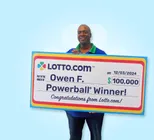 Winner Owen F. holds a check for $100,000 in his hands